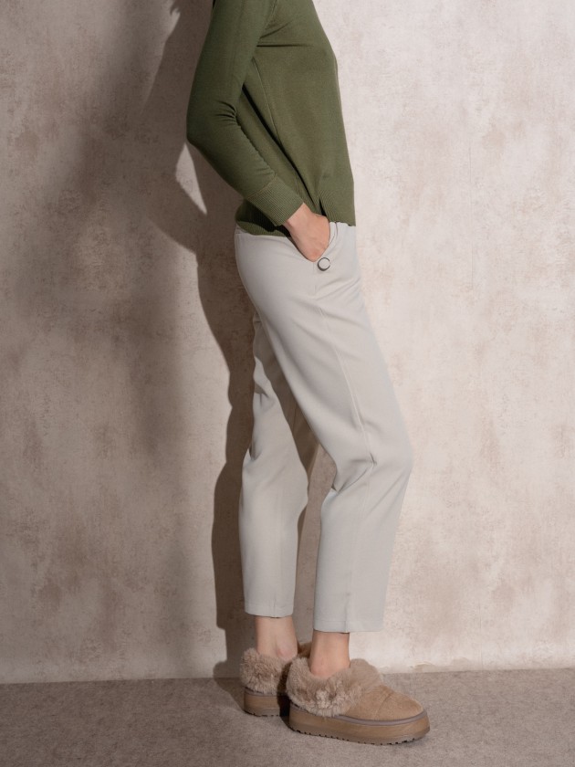 Pants with button application on pockets