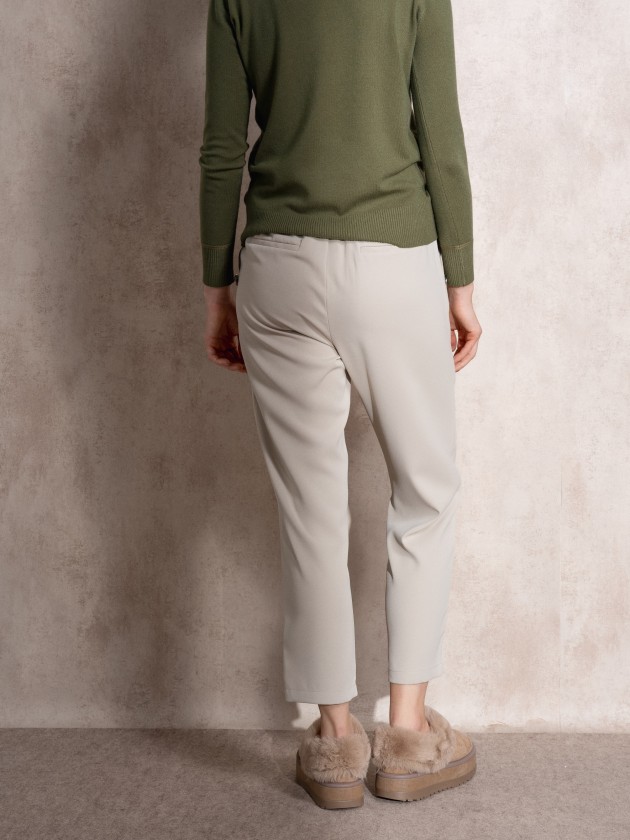 Pants with button application on pockets