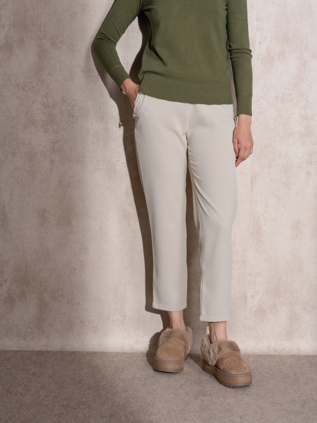 Pants with button application on pockets