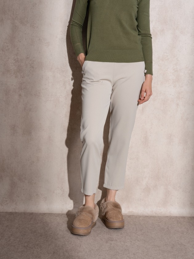 Pants with button application on pockets