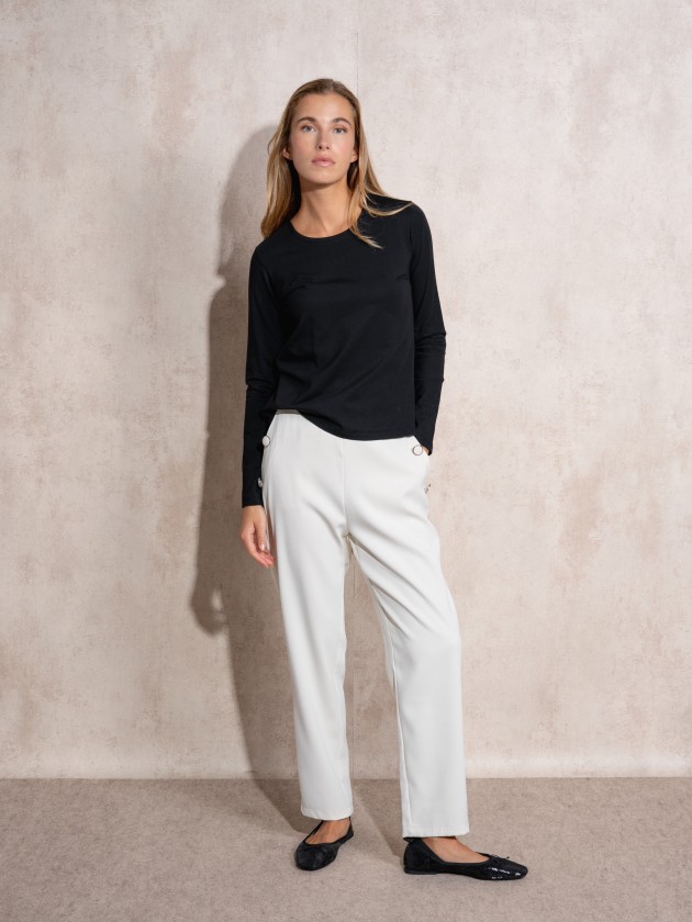 Pants with button application on pockets