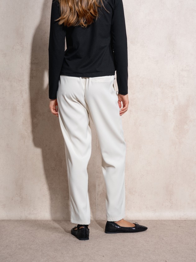 Pants with button application on pockets