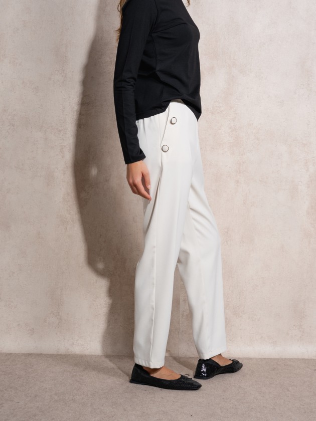 Pants with button application on pockets