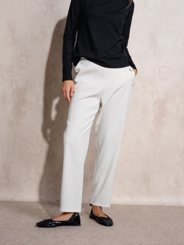 Pants with button application on pockets