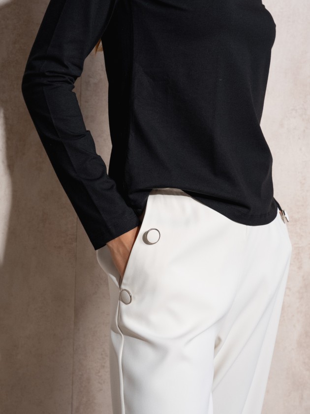 Pants with button application on pockets