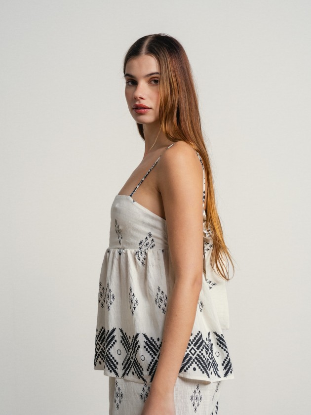 Printed tank top with thin straps and a slightly open back. Printed tank top with thin straps and a slightly open back.