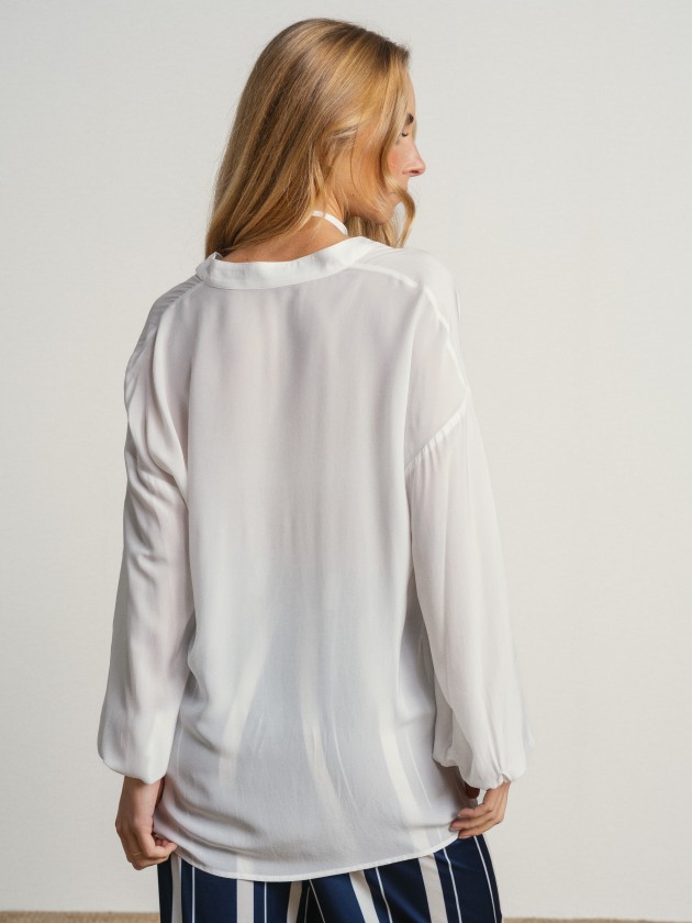 Shirt with a v-neck and drawstring waist. Shirt with a v-neck and drawstring waist.