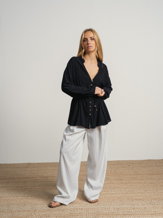 Shirt with a v-neck and drawstring waist. Shirt with a v-neck and drawstring waist.