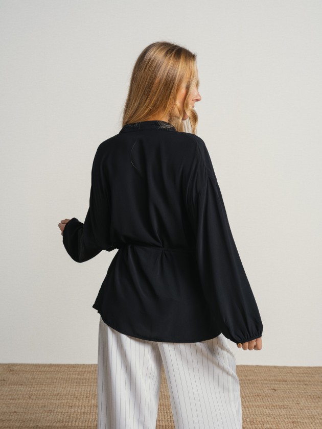 Shirt with a v-neck and drawstring waist. Shirt with a v-neck and drawstring waist.