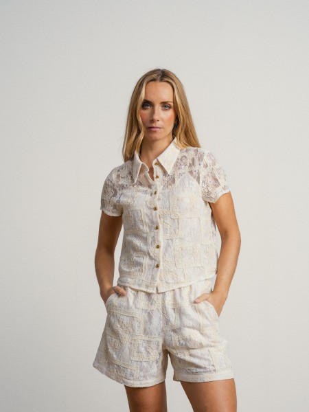 Lace shirt with inner lining and straps.
