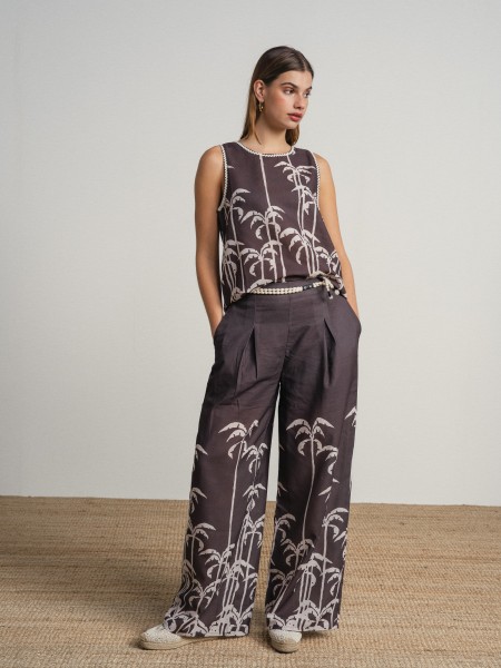 Sleeveless top with palm tree print.