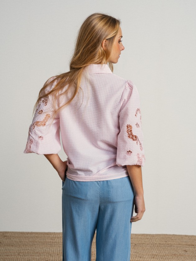Shirt with embroidery on the sleeves.