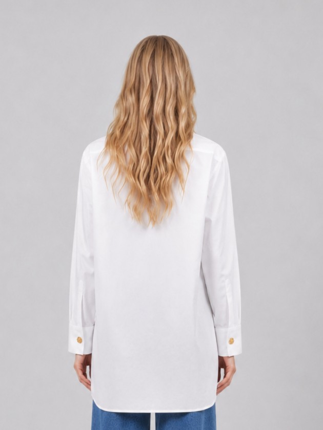 Cotton shirt with gold buttons on the side. Cotton shirt with gold buttons on the side.