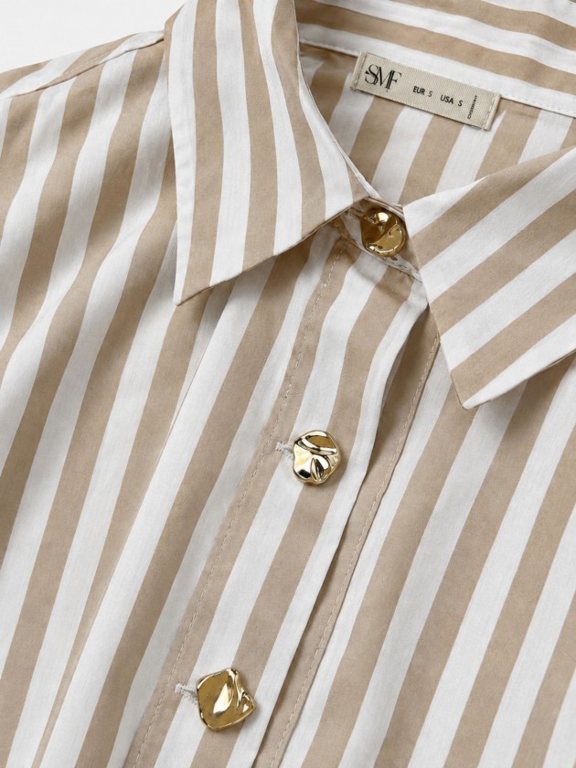 A shirt with rich, metallic buttons.